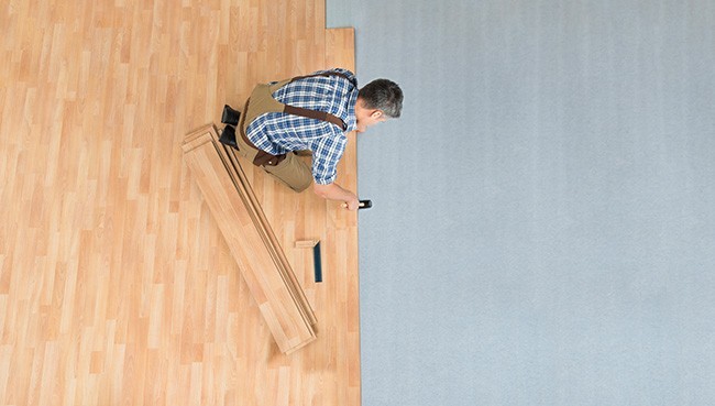 Worker Assembling New Laminate Floor | Mills Floor Covering