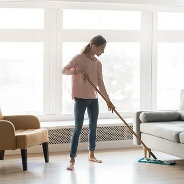Young woman housewife clean floor | Mills Floor Covering